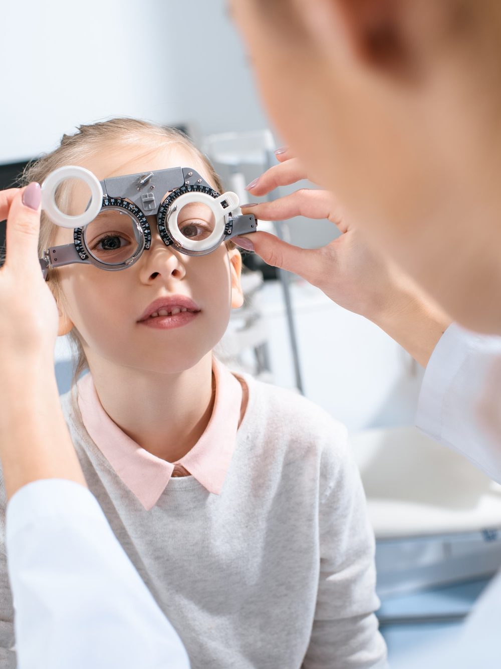 selective-focus-of-ophthalmologist-examining-kid-eyes-with-trial-frame-in-clinic.jpg